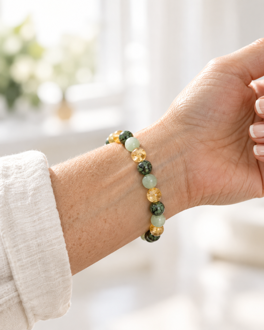 A woman wearing the Plentia bracelet on the inside of her left wrist, over the pulse